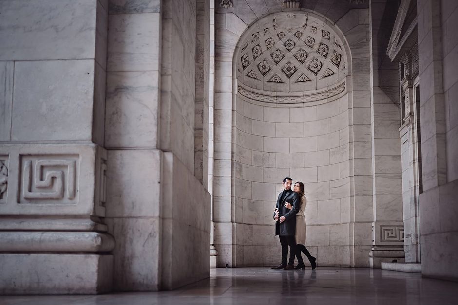 Tanya and Sunny standing in a hall in front of the New York Public Library